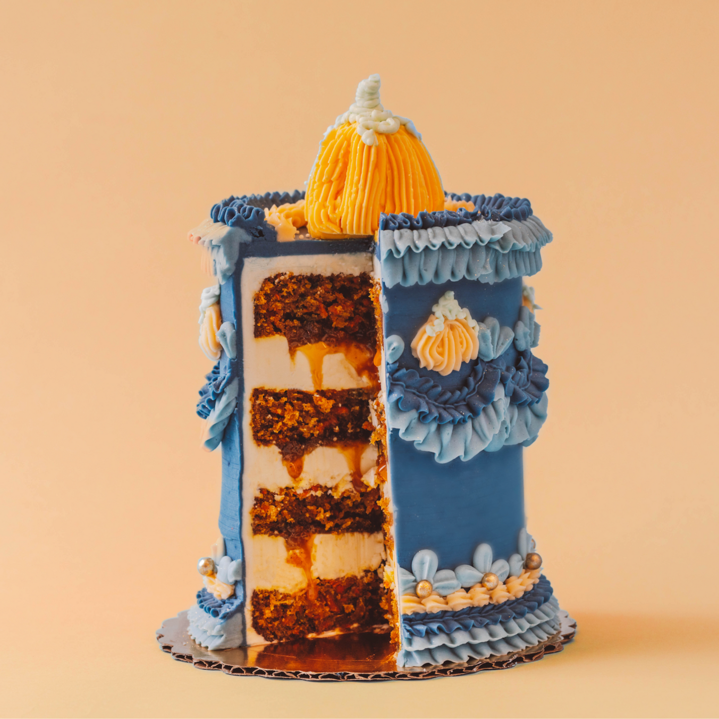 Decorative cake with blue and yellow layers on a beige background