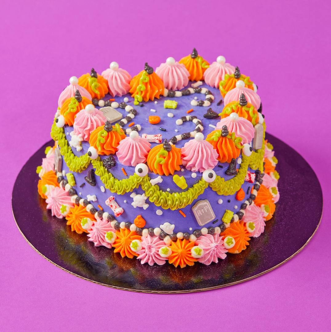Colorful Halloween-themed cake on a purple background