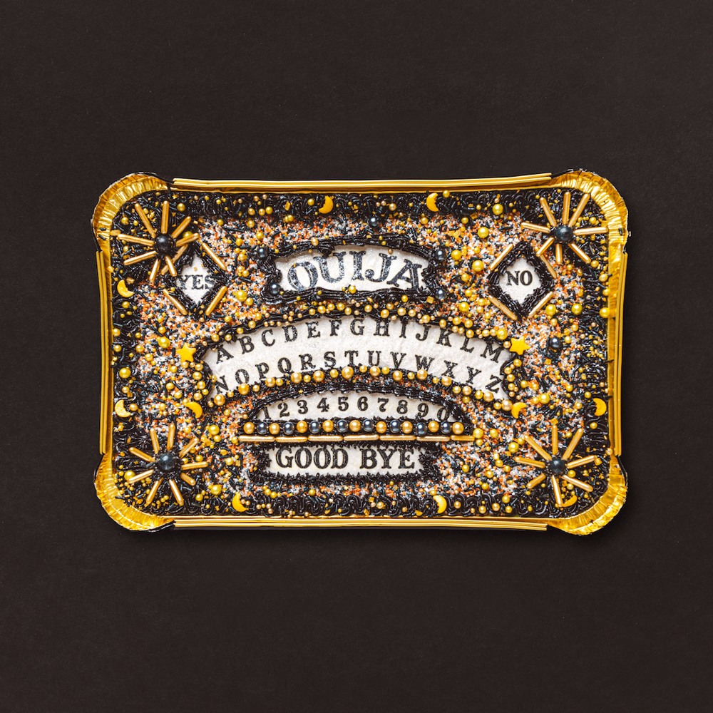 Decorative cake with text and gold embellishments on a black background