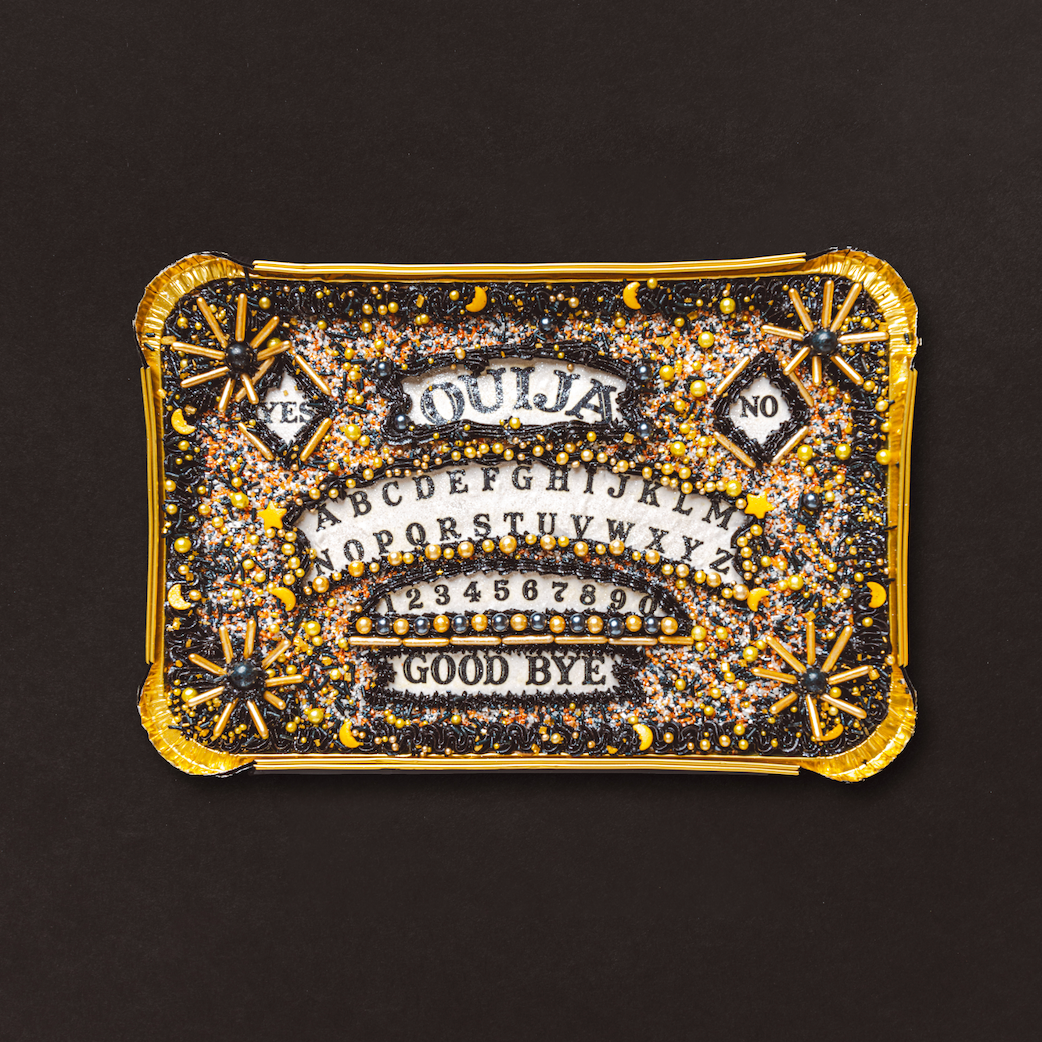 Decorative cake with text and gold embellishments on a black background