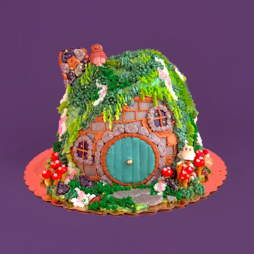 Fairy house with green roof and blue door on a purple background