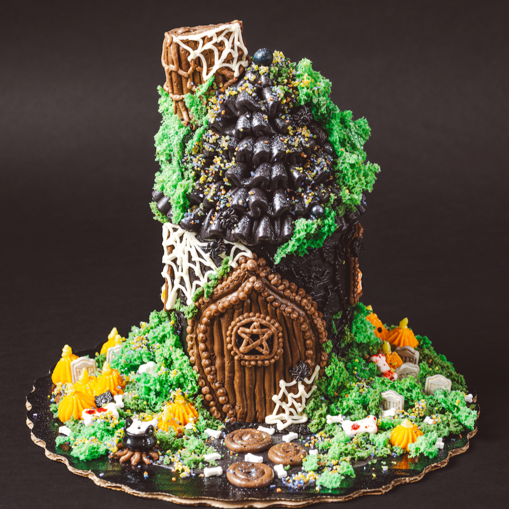 Gingerbread house with decorative elements on a dark background